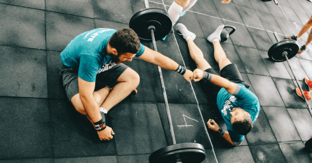 two men lying on the floor after a hard workout two men lying on the floor after a hard workout