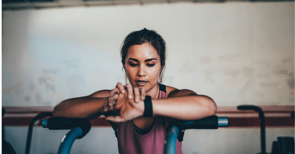 woman looking at a watch in the gym woman looking at a watch in the gym