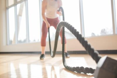 woman-exercising-with-battle-ropes-in-a-sunny-gym_t20_989NVy-1-scaled-1